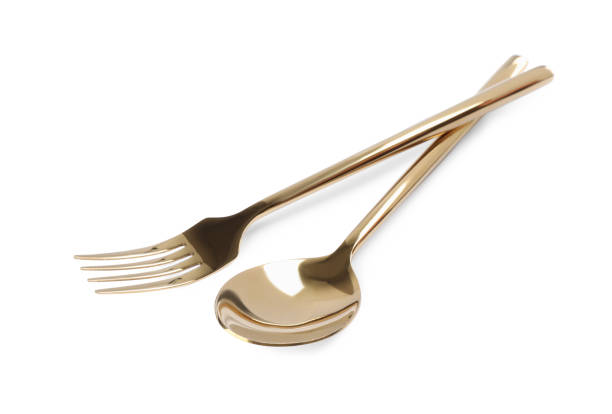 istock New shiny golden fork and spoon on white background 1426575506