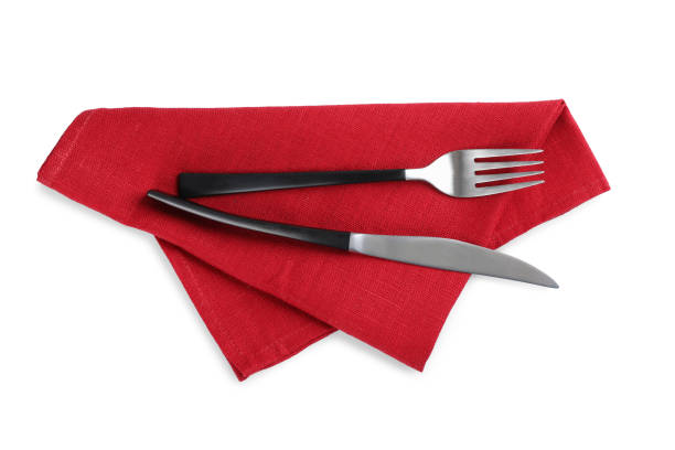 istock Red napkin with fork and knife on white background, top view 1426575870