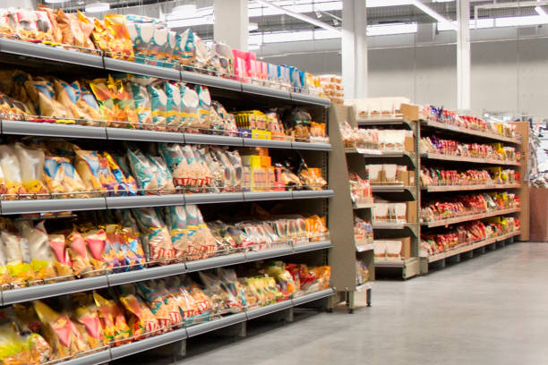 snacks and chips on self at supermarket - ice shelf imagens e fotografias de stock