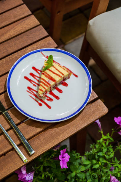 istock Cheesecake with jam and mint in a plate on the bedside table with cutlery against a background of flowers 1426584202