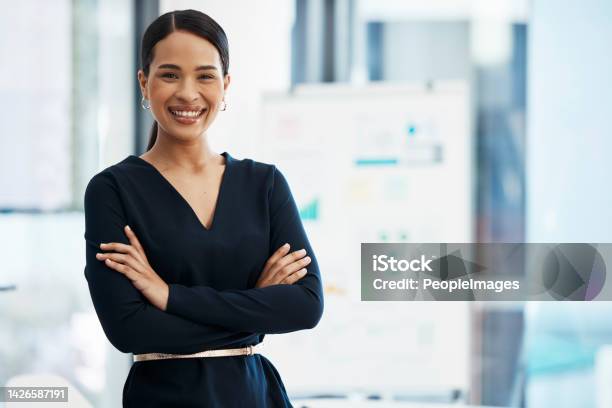 Confident Happy And Smiling Business Woman Standing With Her Arms Crossed While In An Office With A Positive Mindset And Good Leadership Portrait Of An Entrepreneur Feeling Motivated And Proud Stock Photo - Download Image Now