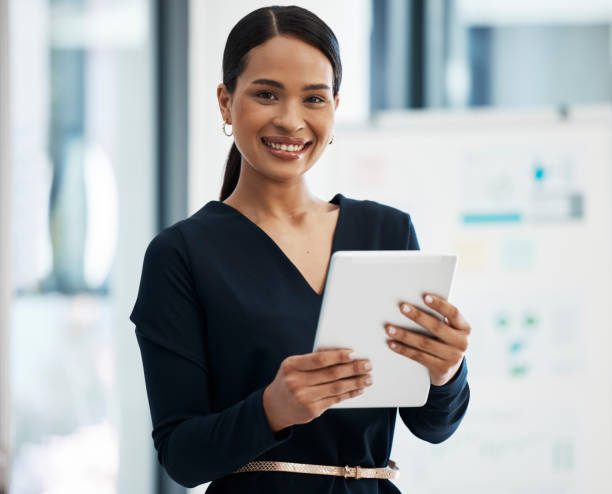 istock Professional female marketer with digital tablet planning, working or coming up with new ideas, plans or strategy. Woman doing social media marketing for new startup business and updating websites 1426587193