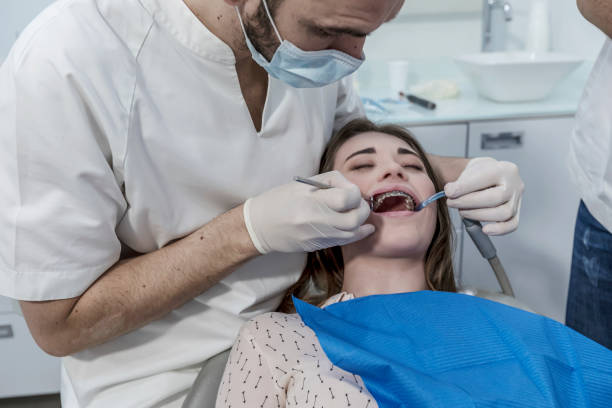 istock Dentist examining little boy's teeth in clinic 1426587471