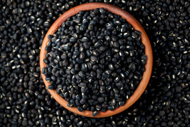 istock Black Lentils (Maa de Daal, Black matpe beans, Black urad, urad whole). Lentils in Pottery 1426587691