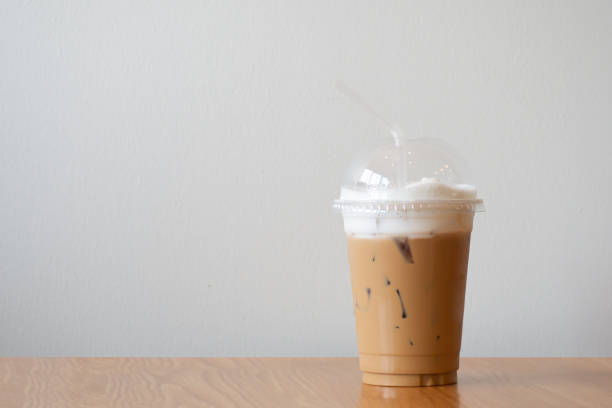 istock ice cappuccino in plastic cup on wooden table.  Copy space with white background. 1426587986