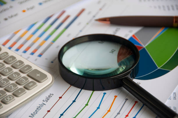 istock Magnifying glass on graph analysis. Copy space and business analysis concept 1426589168