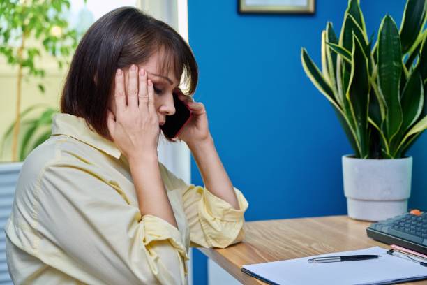 istock Sad middle aged woman talking on the phone 1426603747