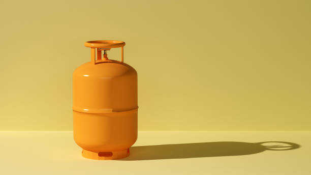 orange gas cylinder on yellow background in a beam of light - botija de gas imagens e fotografias de stock