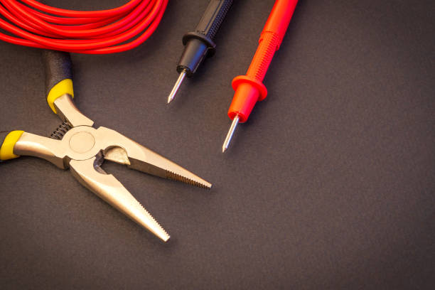 istock Electrician tool and tester terminals on black background for repairing energized systems or communications 1426605723