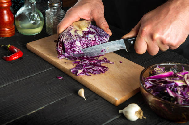 istock The chef is cutting red cabbage with a knife. Cooking vegetable salad in the restaurant kitchen. Vegetable diet idea 1426606855