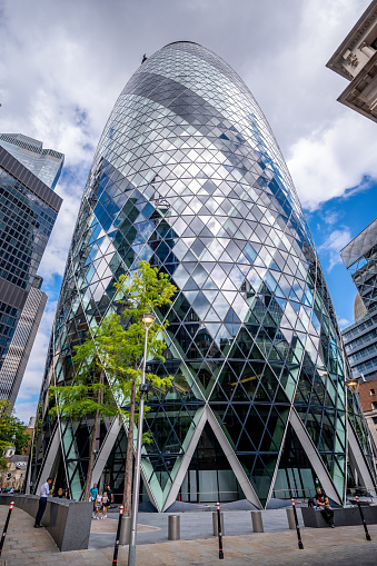 London, UK - August 25, 2022: Skyscraper at 30 St Mary Axe, also known as the Gherkin, and is an Iconic building in the City of London business district.
