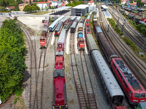 Cargo trains close-up. Aerial view of colorful freight trains on the railway station. Wagons with goods on railroad. Heavy industry. Industrial conceptual scene with trains. Top view flying drone.
