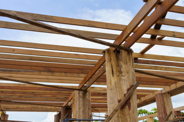 istock A wooden frame structure with massive supporting pillars prepares the construction of a two-story house. 1426613913