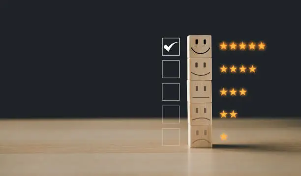 Photo of Choosing wood blocks with five star icons to give satisfaction in service. Operator correct data quality assistance control care. positive customer review experience. feedback rating very impressed.