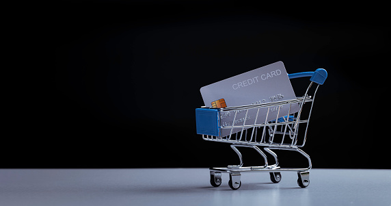 The credit card is in the shopping cart. the concept of e-commerce, business supermarket, online payment, promotion marketing,