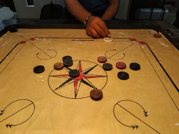 istock Striking the coins by striker on carrom board 1426624903