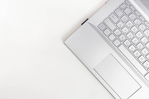 istock A laptop are on a white table. Top view with copy space 1426627540