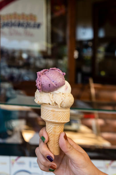 istock Ice Cream Cone In Hand Close-Up With Bokeh 1426634109