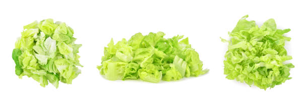 Heap of sliced green lettuce isolated on white Heap of sliced green lettuce isolated on white background. green leaf lettuce stock pictures, royalty-free photos & images
