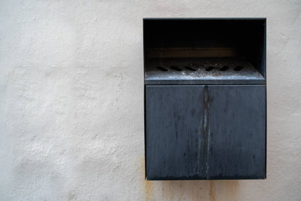 istock Black metal wall mounted ashtray in public with copy space 1426637376