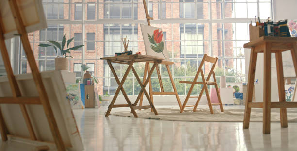 istock Art, painting and creativity with artwork in an empty studio for creative, design and artistic freedom or expression. Picture, drawing and easel with a still life flower on a canvas in a gallery 1426645876