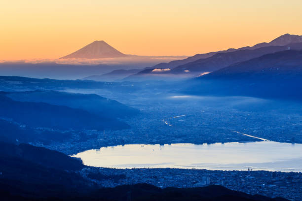 Mount Fuji of the morning glow from Takabochi Highland View of Mount Fuji and Suwa lake in morning from Takabochi Highland, Mountain Takabochi, Nagano prefecture, Japan. suwa lake photos stock pictures, royalty-free photos & images
