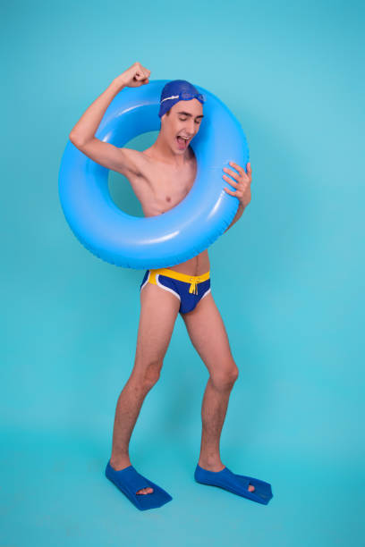 istock Funny guy with an inflatable ring in the pool. 1426651094