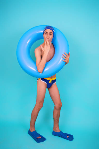 istock Funny guy with an inflatable ring in the pool. 1426652468