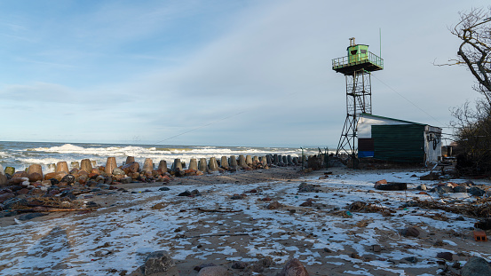 The seashore of the Baltic sea with the Watchtower and a barn.