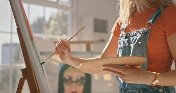 istock Painting, canvas and art with woman and creative workshop studio for drawing, design or illustration. Artist, inspiration and vision with young female painter for hobby, learning or talent 1426655093