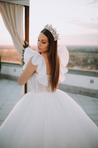 istock Beautiful bride posing in white princess dress with crown. 1426655123