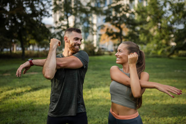 istock Shot of a young couple stretching before a run 1426658823