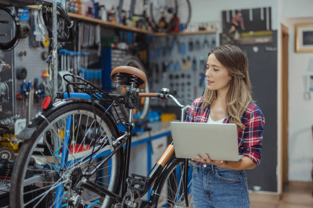 istock Repair Bicycle Mechanic using Laptop 1426661259