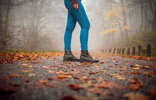 Woman walking alone in the autumnal park