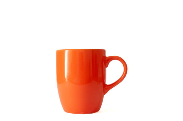 istock Shiny bright ceramic orange color tea cup or mug isolated on white background. 1426666105
