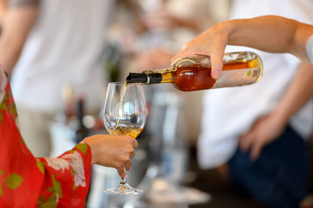 Bartender pouring rose wine for tasting Bartender pouring rose wine for tasting, woman is holding her wineglass to fill it food festival stock pictures, royalty-free photos & images