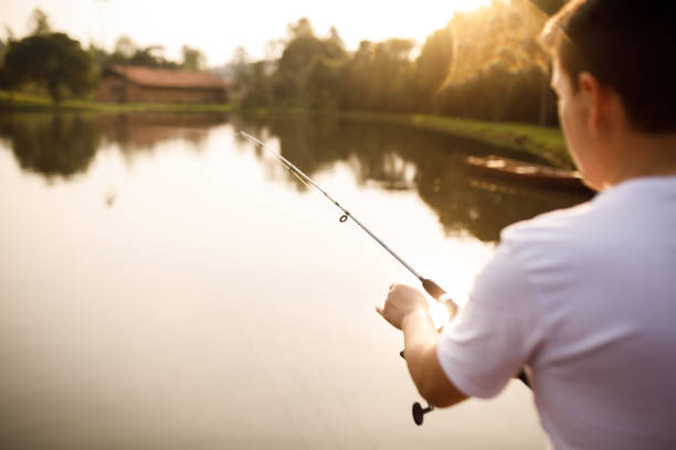 istock Young man fishing on a lake 1426671830