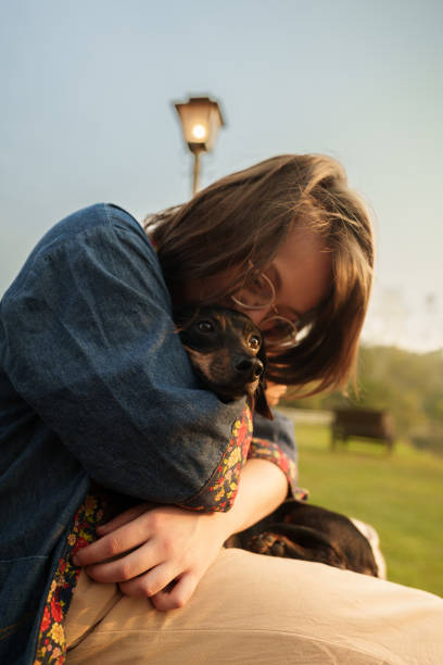 istock Young woman hugging and kissing her dog 1426672149