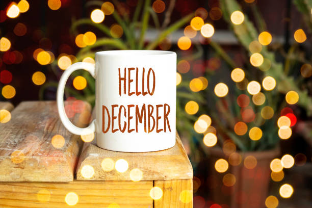 istock Hello December written on white coffee cup on  wooden table with bokeh background 1426672174