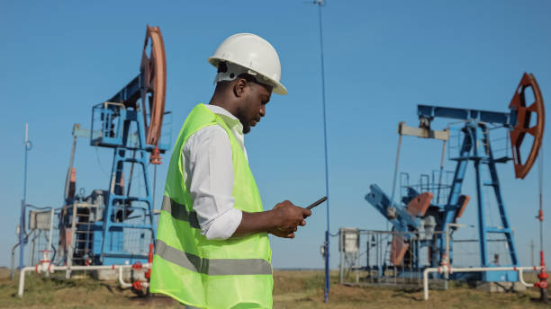 istock Black engineer controls development of oil by jack-pump 1426672280