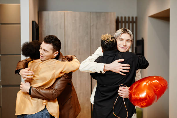 istock Two happy young homosexual couples greeting each other by embracing 1426672467
