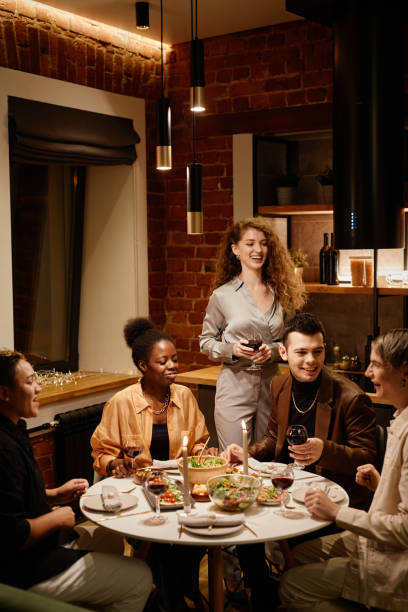 istock Happy young multicultural friends having chat by served festive table 1426672596
