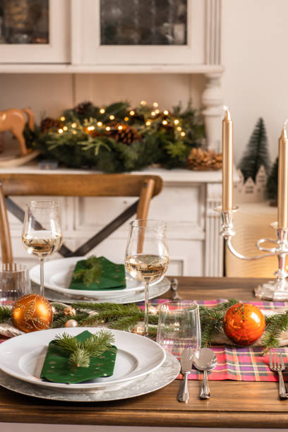 istock Christmas festive table with place setting and wine in bright rustic kitchen 1426672958