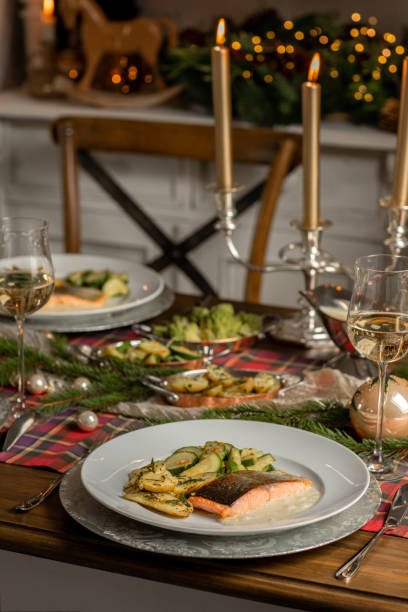 Christmas festive fish dinner with salmon fillets and Mediterranean vegetables in rustic kitchen home