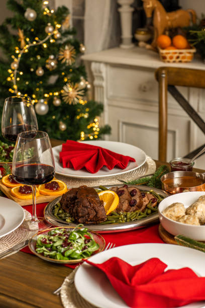 istock Christmas dinner roast beef venison with gravy and cranberries in rustic kitchen home 1426674179