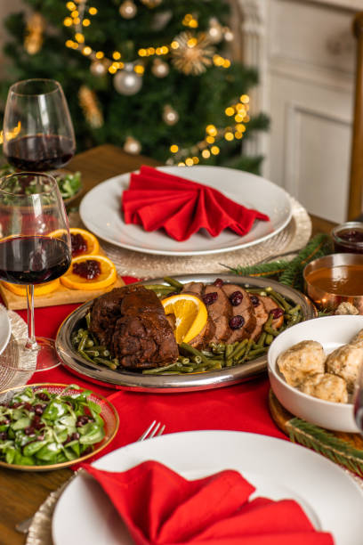 istock Christmas dinner roast beef venison with gravy and cranberries in rustic kitchen home 1426674299