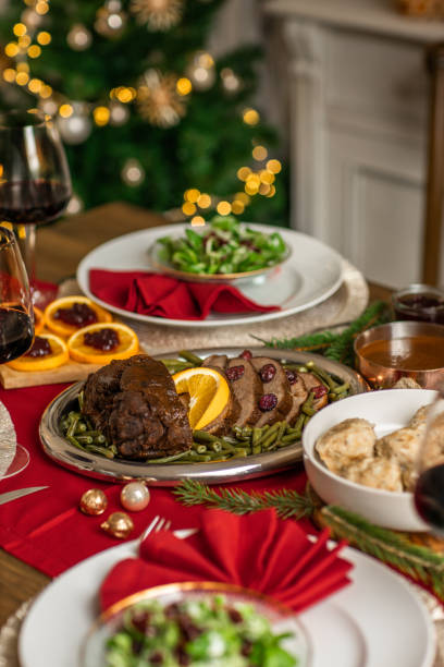 istock Christmas dinner roast beef venison with gravy and cranberries in rustic kitchen home 1426675140