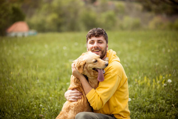 istock Guy and his dog, golden retriever, nature 1426677412