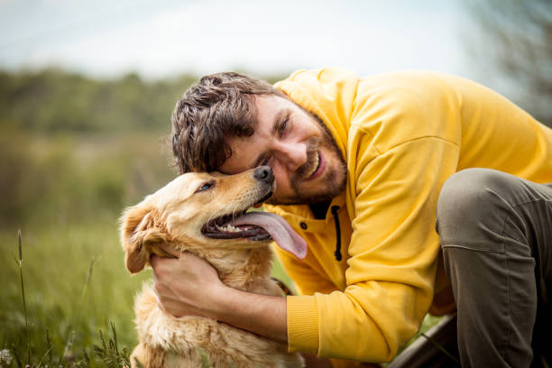 istock Guy and his dog, golden retriever, nature 1426677416