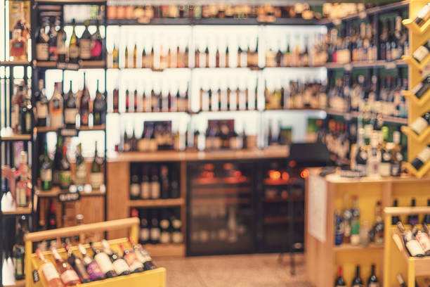 defocused wine shop with wine bottle racks - indoors luxury restaurant store imagens e fotografias de stock